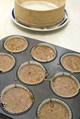 Raw dough into muffins in the forms