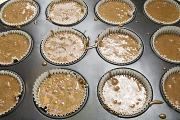 Raw dough into muffins in the forms