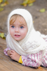 Portrait of the small beautiful girl in a white kerchief