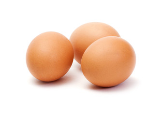 Three brown eggs on white background