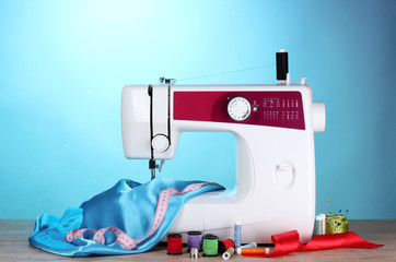 sewing machine and fabric on blue background