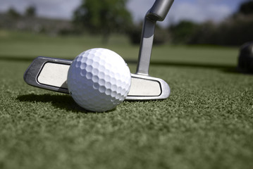Golf ball and putter at address