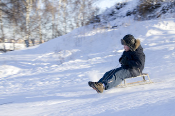 Fototapeta na wymiar boy sledding