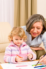 Fototapeta premium Little girl with grandmother drawing together