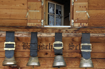 Swiss cow bells hanging outside traditional chalet