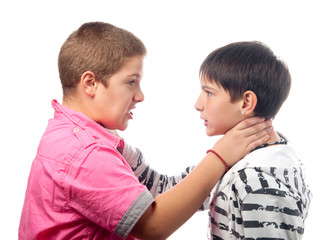 Two angry teenage boys holding each other necks during the fight