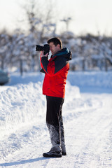 Tourist with camera in the winter