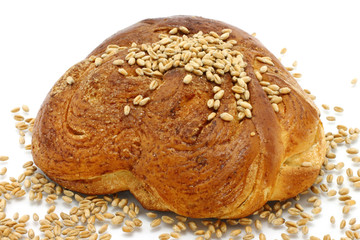 Sweet loaf with wheat on a white background