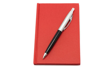 Red notepad with ball pen on a white background