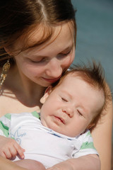 mother and baby on natural background