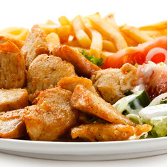 Grilled meat with French fries and vegetables