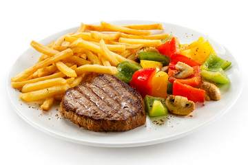Grilled steak, French fries and vegetables