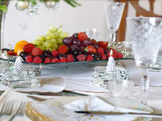 Holiday place setting with fruit tray and candles