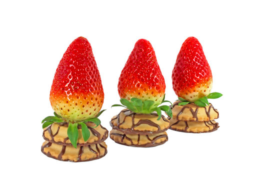 Three fresh strawberries on a cakes