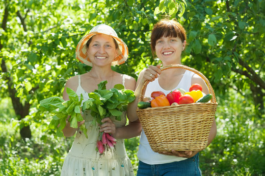 Two happy women with vegetables