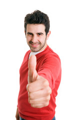 Happy casual young man showing thumb up and smiling isolated on