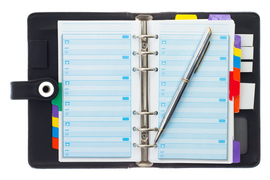 Personal black organizer with pen.