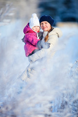 Fototapeta na wymiar Mother and daughter outdoors at winter