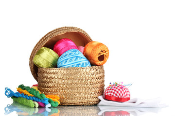 Fototapeta na wymiar bright threads for needlework and fabric in a wicker basket