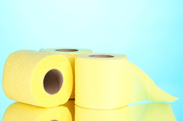 yellow rolls of toilet paper on blue background