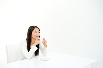 attractive asian woman drinking in the white room