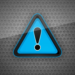 Hazard warning attention symbol on a dark gray metal surface