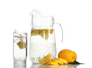 pitcher and glass of lemonade and lemon isolated on white