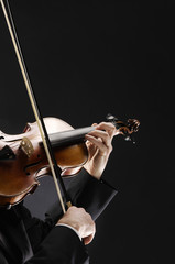 the violinist: Musician playing violin on dark background