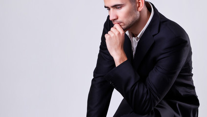 Portrait of a handsome young business man on a gray background