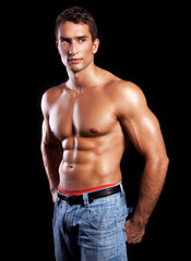handsome powerful muscular man isolated on black - obrazy, fototapety, plakaty