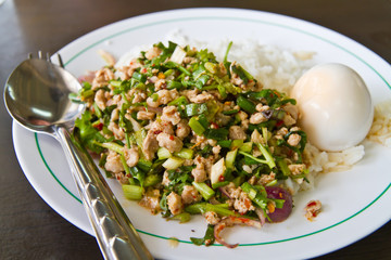 Cooked rice with spicy minced meat salad and boiled egg