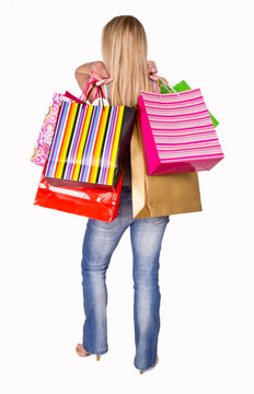 Blond woman with shopping bags on white background