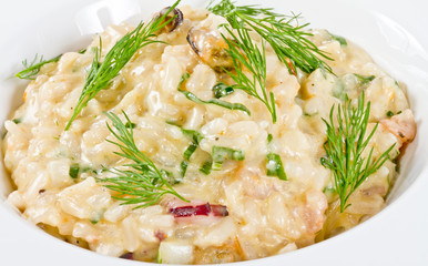 photo of delicious risotto with seafood and dill on it