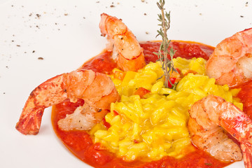 Plate of Shrimps Risotto garnished with fresh parsley and Parmes