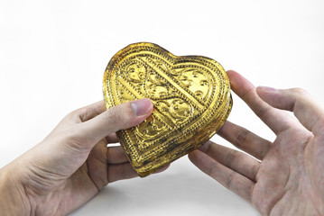 Hands holding golden heart