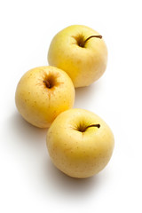 Three yellow apples on white