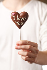 man with chocolate heart in the hands