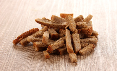 Appetizing rusks in on wooden background