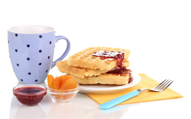 Tasty waffles with jam on plate isolated on white