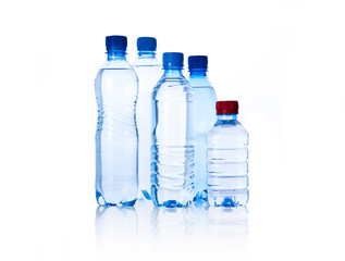 Naklejka premium Group plastic bottles of water isolated on white