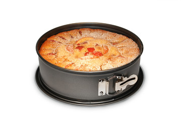 Homemade apple pie in a baking dish on white isolated background