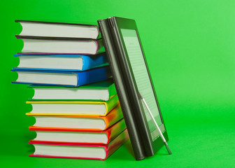 Electronic book reader with stack of printed books