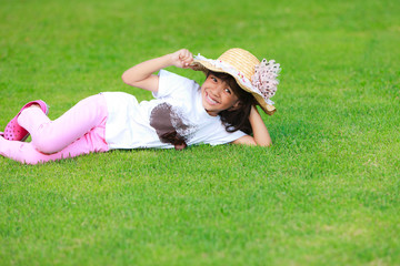 Little gril on green grass