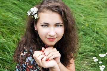 Portrait of a beautiful young brunette with flowering branches
