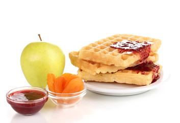 Tasty waffles with jam on plate isolated on white