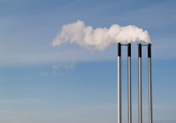 Four chimneys on a blue sky