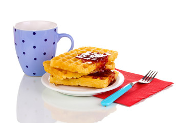Tasty waffles with jam on plate isolated on white