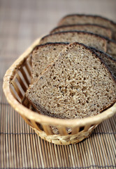 The cut rye bread on a straw support