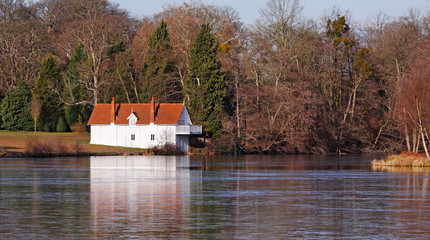 Whitewashed Lakeside Boathouse in Winter sunshine © Chris Lofty