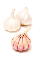 Rose or pink garlic bulbs isolated on a white studio background.